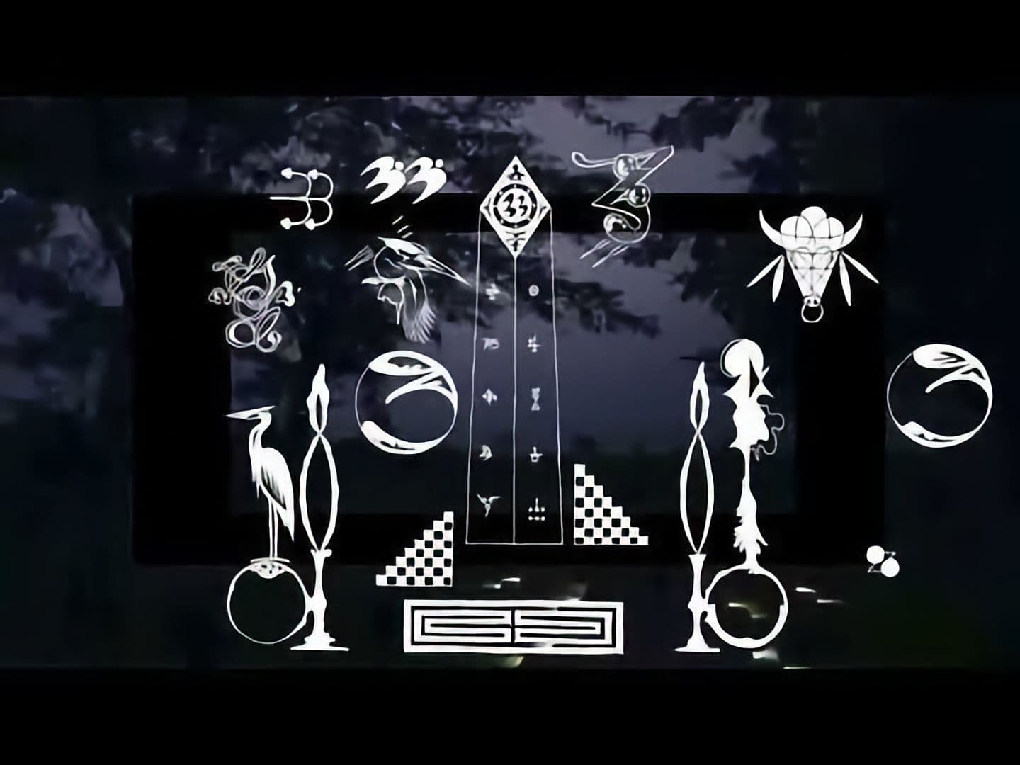 A dark-themed video screen displaying white symbols against a black backdrop.